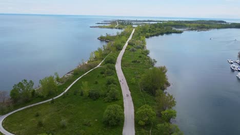 aerial shot of bike path surrounded by water - slow push in