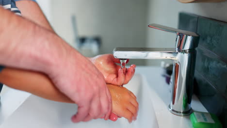 Parent,-child-and-washing-hands-in-bathroom