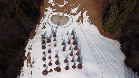 aerial flying overhead snow covered tree cathedral on hillside located near pizzo arera