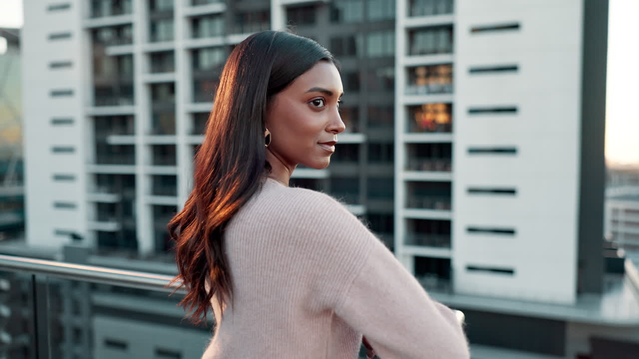 Woman on a rooftop overlooking a city