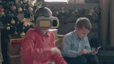 cute schoolboys in colorful shirts use modern gadgets