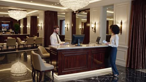 hotel receptionist checking in guest