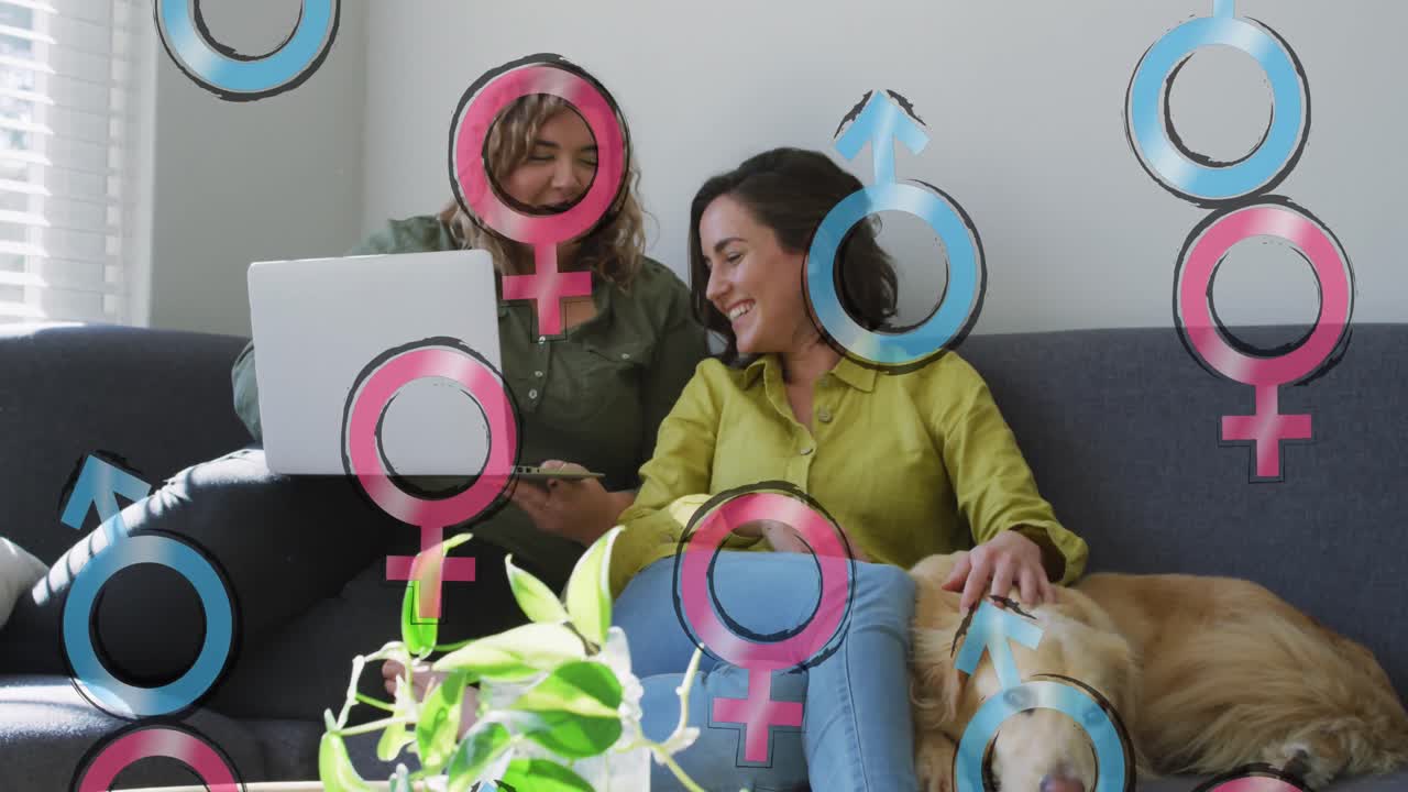 animación de símbolos masculinos y femeninos sobre una pareja de lesbianas usando una computadora portátil