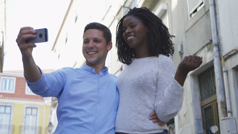 Happy-young-couple-posing-for-selfie-outdoor.