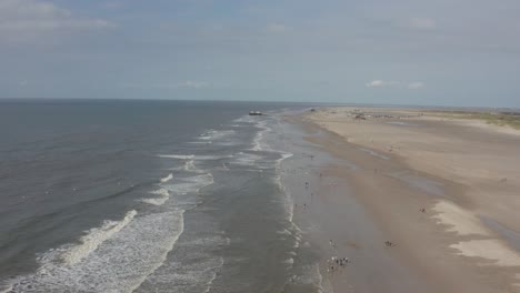 drone - aerial shot of the sandy beach with tourists and people in st. peter ording at the north sea, schleswig holstein, germany, 25p