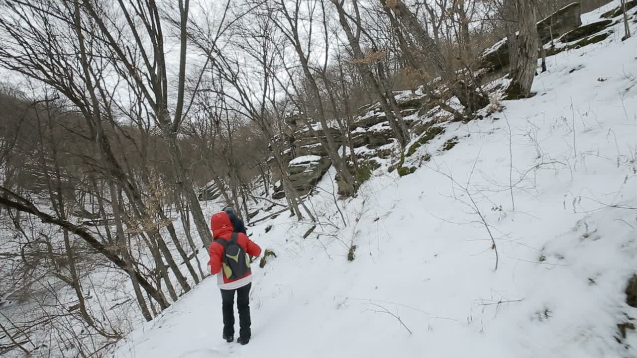 Man and woman hikers trekking in snowy hills