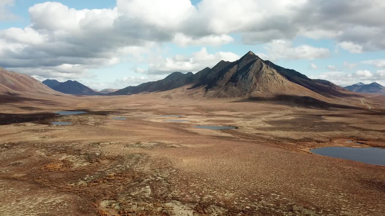 Very cinematic drone shot of Yukon Tundra and mountains