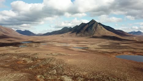 very cinematic drone shot of yukon tundra and mountains