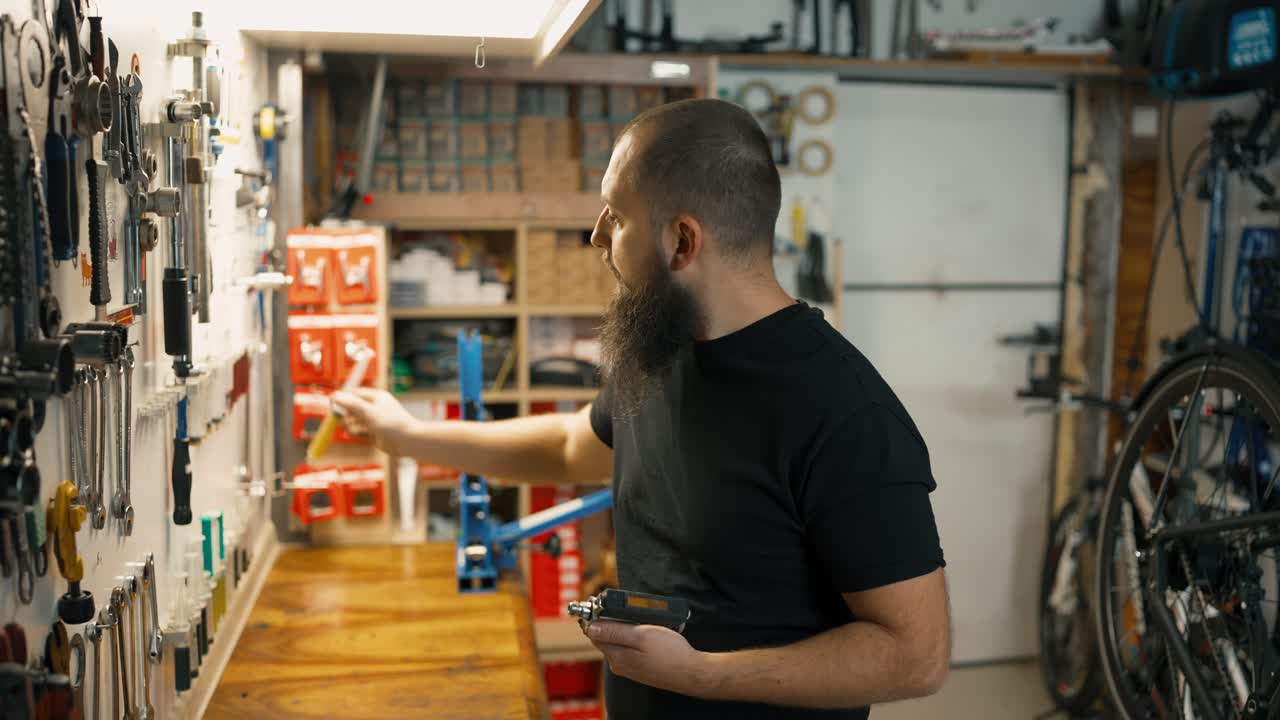 Workshop repairing bicycles the master lubricates the pedal assembly for maintenance