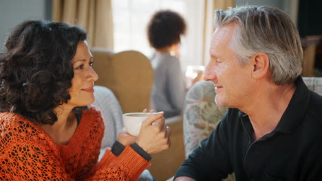 middle aged couple sitting around table in coffee shop