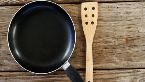 wooden spoon and a pan on the table