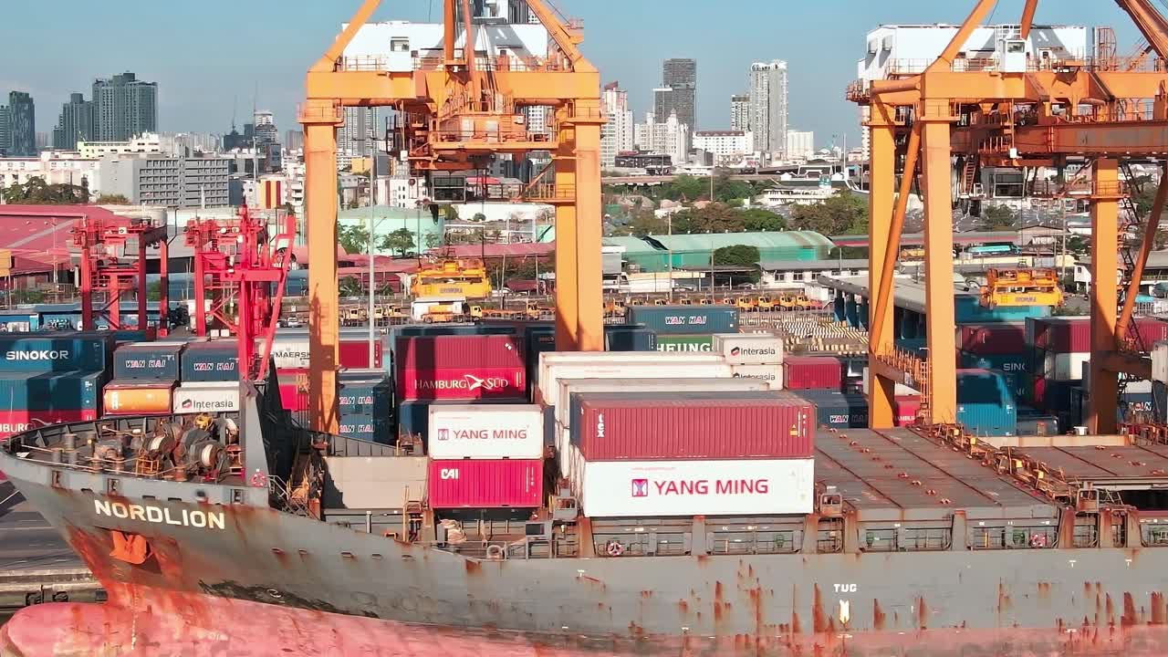 Containers are unloaded at the port in Bangkok during daytime