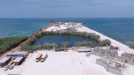 aerial flyover constriction site with trucks and machinery on new terminal project named cabo rojo in pedernales