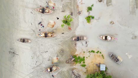 Hölzerne-Fischerboote-Am-Strand-Von-Kuakata-Mit-Fischern,-Die-Reparaturen-Durchführen