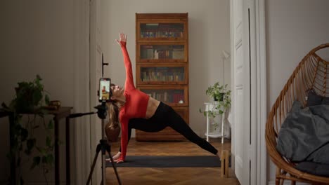 woman practicing trikonasana yoga pose at home