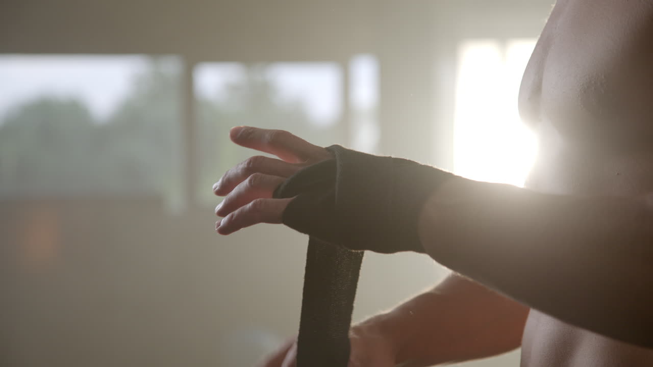 Man wrapping hands for boxing workout