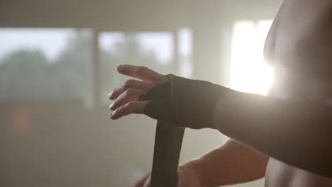 man wrapping hands for boxing workout