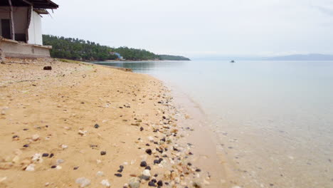 Aerial-footage-of-a-low-pass-flight-on-a-tropical-sand-beach-in-Cebu,-Philippines,-Asia,-Drone