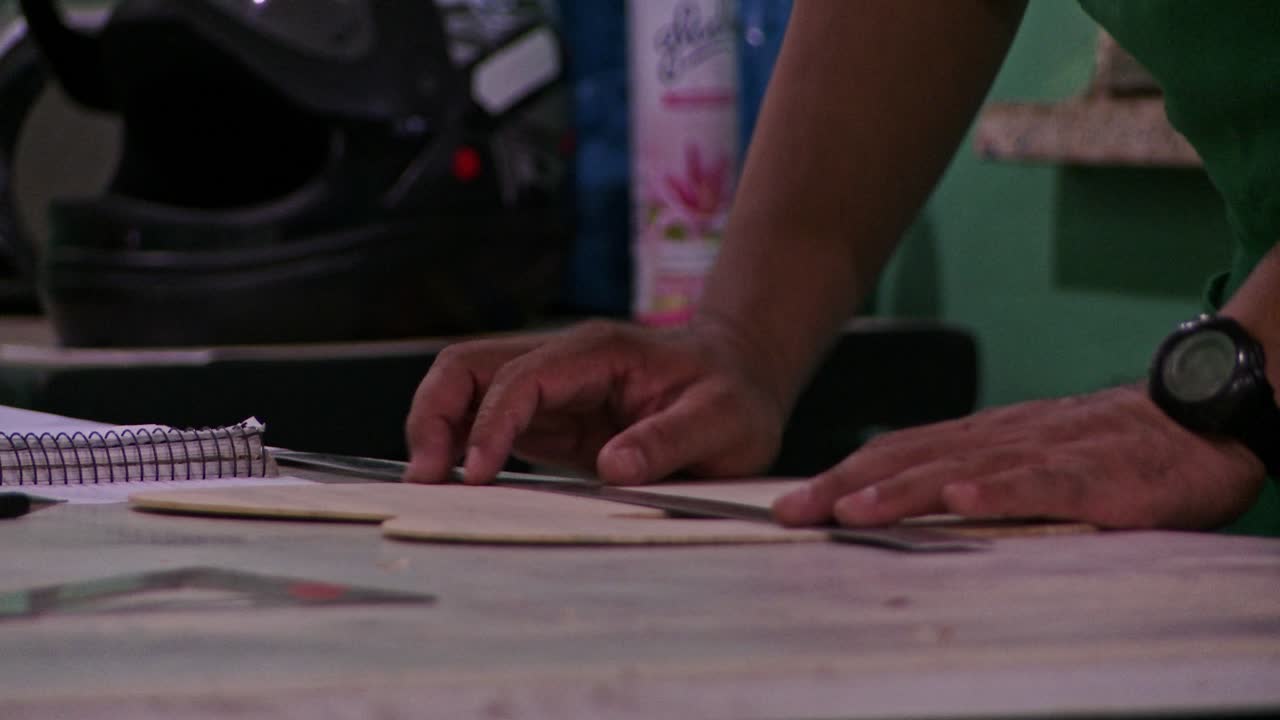 Refining the wooden shape of a handmade acoustic guitar