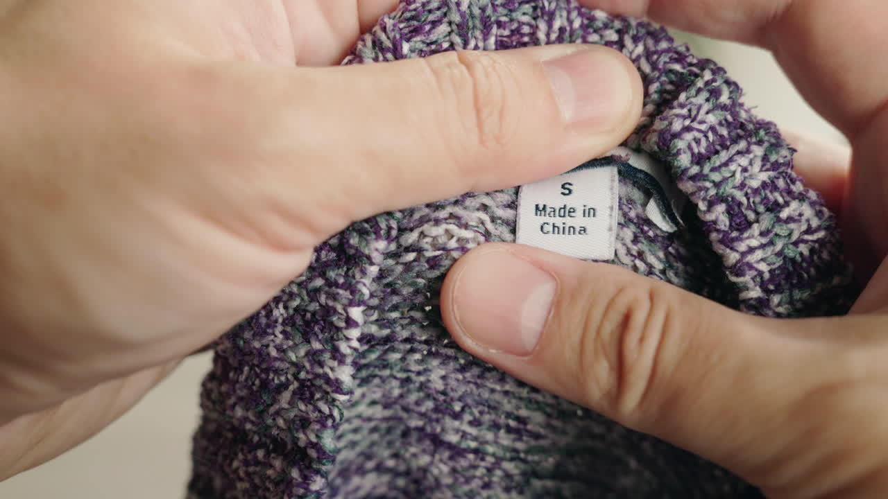 Close-up of a clothing tag with size S and Made in China