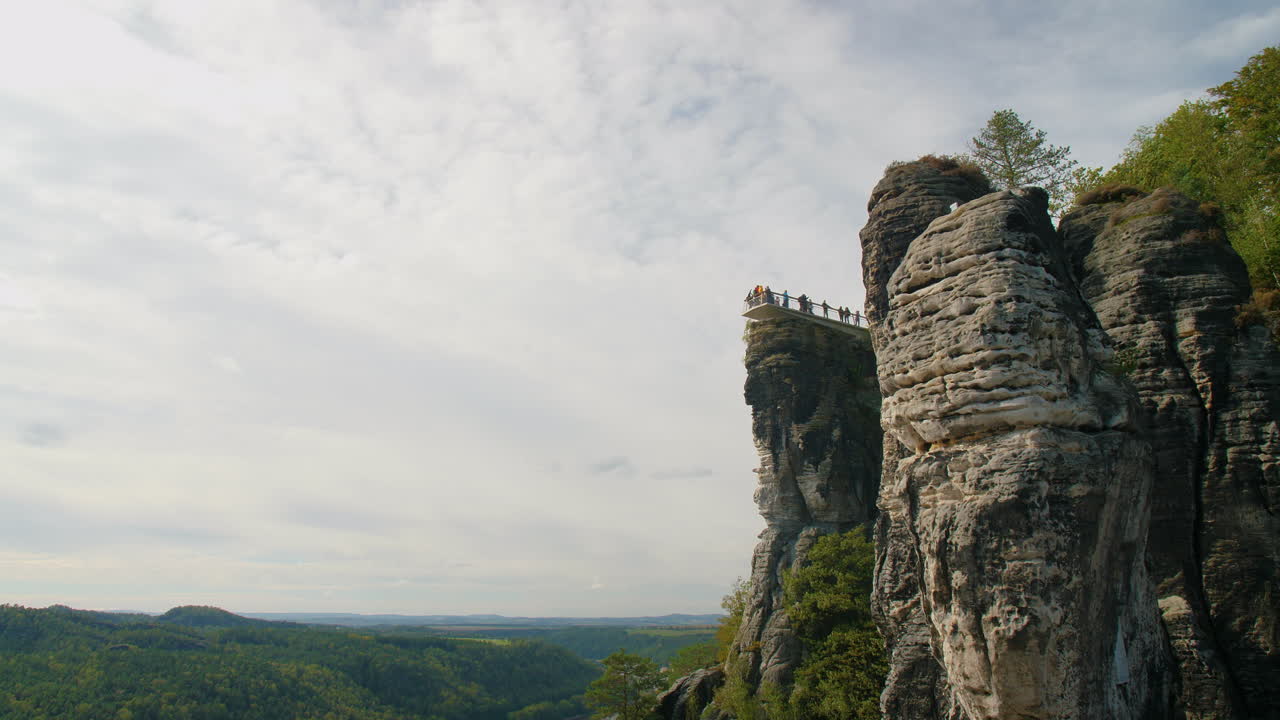Observation platform Elbsandsteingebirge Sachsen Elbe sandstone formations rising above dense green forests Mountains, under a blue sky with scattered clouds