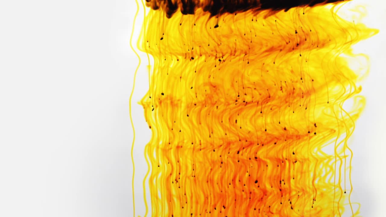 Colorful chemical liquids mix and swirl in water, forming smooth abstract patterns and organic shapes