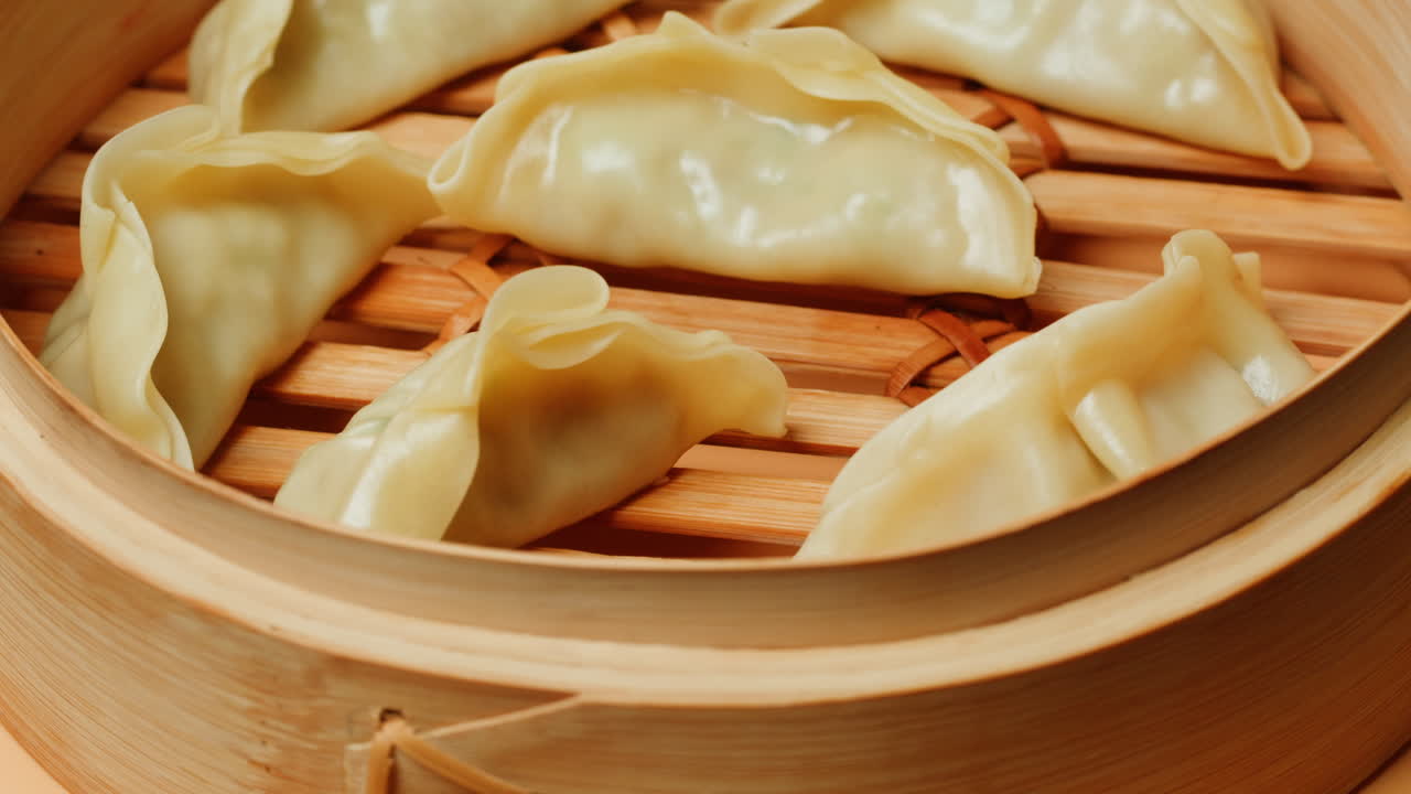 Freshly Steamed Dumplings Rotating in a Bamboo Steamer