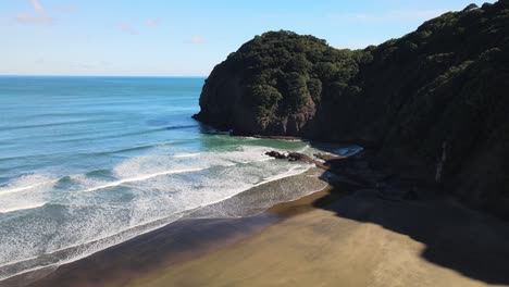 reflections at low tide on black sand beach