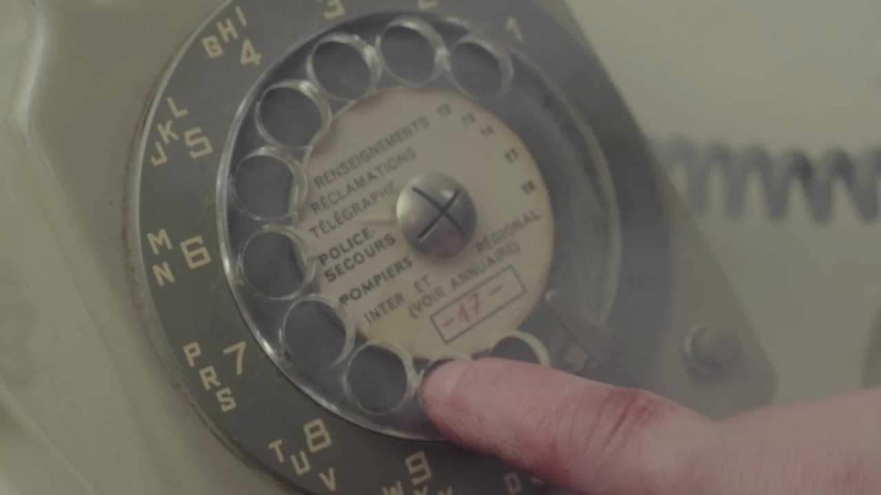 Bload stained hand calling 911 on vintage retro phone in smoke filled room