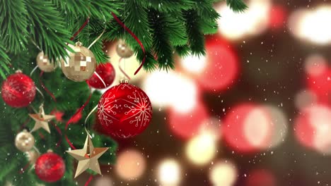 Animation-of-snow-falling-over-red-and-gold-christmas-baubles-decoration