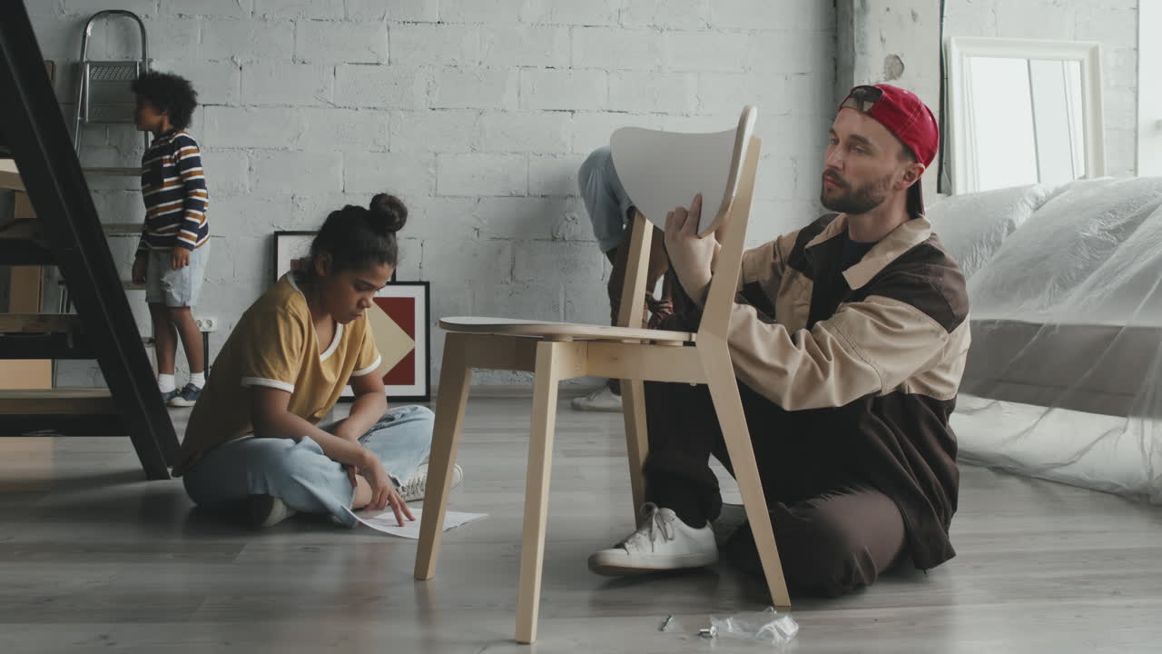 People assembling furniture in a new home