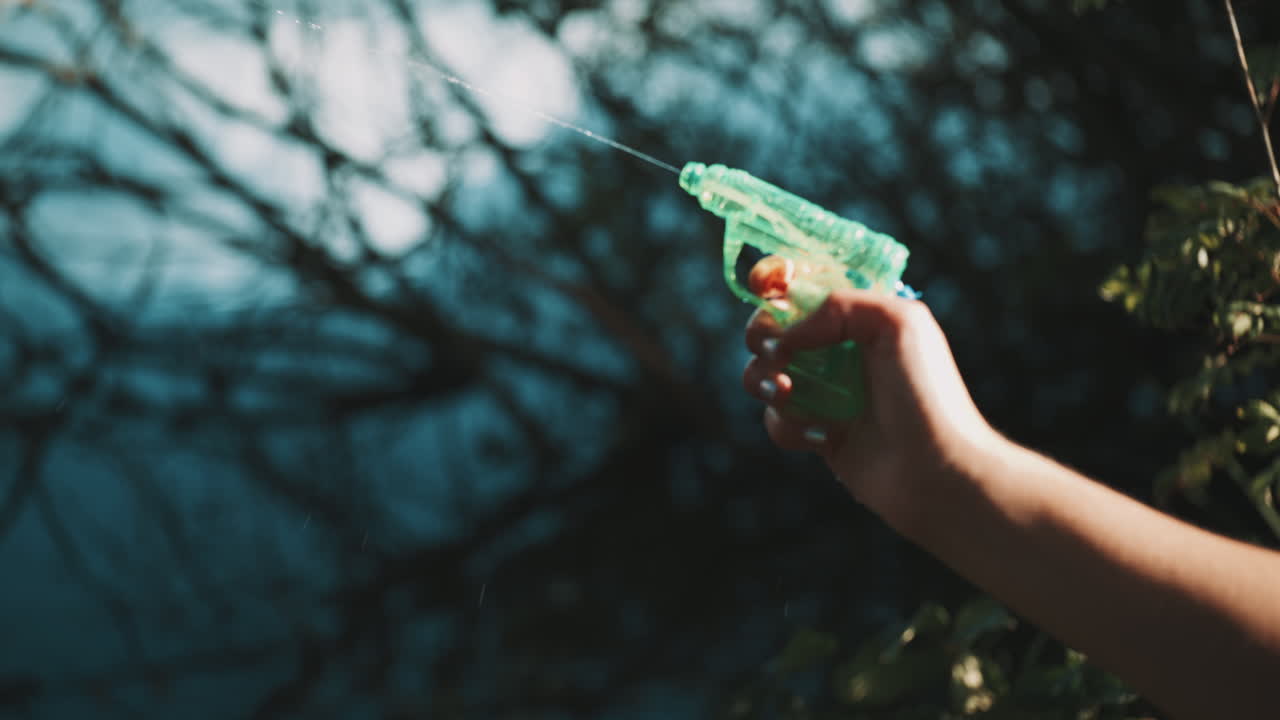 A Person Holding a Water Gun