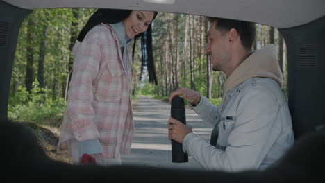 couple enjoying a drink on a road trip
