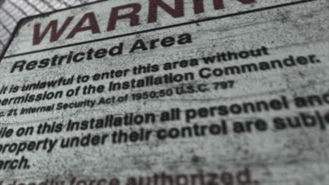 high quality 3d cgi render with a close up orbiting shot of a chainlink fence at a high security installation in a desert scene, with a warning restricted area sign