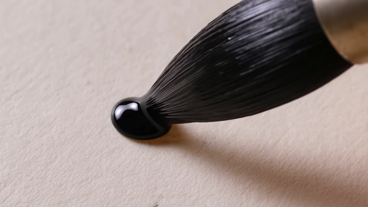 Paintbrush with Black Ink on Textured Paper