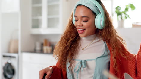 woman dancing and singing in kitchen