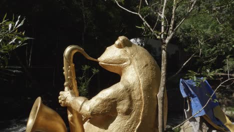 sculpture of a frog playing saxophone at the datanla waterfall in da lat, vietnam