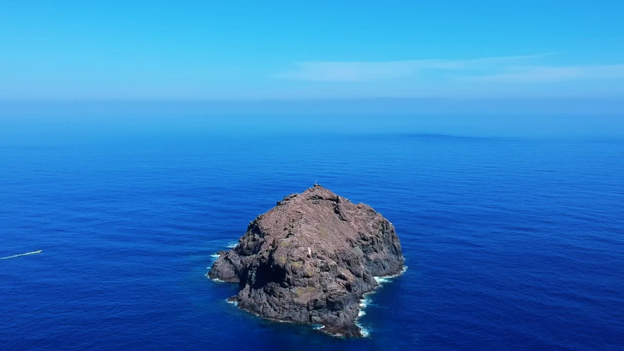 Aeriel drone footage at Garachico - Caleton (Tenerife) next to the blue ocean as the waves hit the rocks in the water
