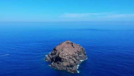 aeriel drone footage at garachico - caleton (tenerife) next to the blue ocean as the waves hit the rocks in the water