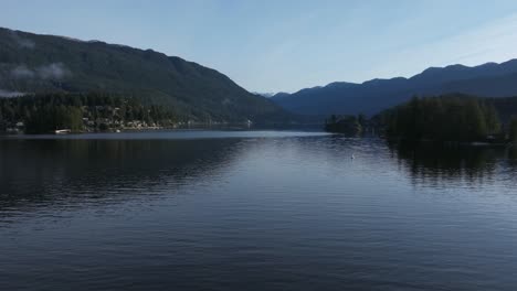 a low altitude shot moving fat above the water indian arm vancouver british colombia