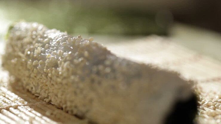 Putting sesame on sushi roll
