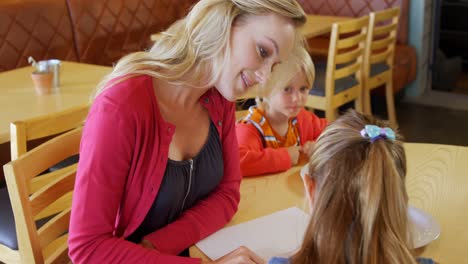 mother and kids looking at menu in restaurant 4k