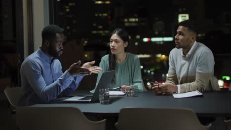 video of african american businessman talking to two diverse colleagues at night in office meeting