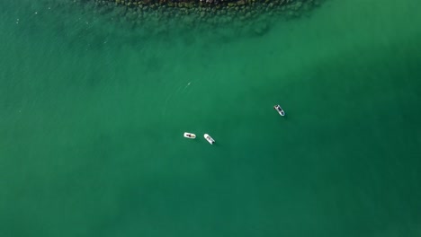 top view of jet-skis floating on the ocean, coast blue-green crystal clear water of dubai's mamzar beach, arabian sea, top tourist attraction, 4k footage