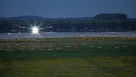 airplane taxiing on runway at night