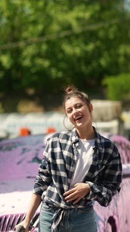 woman washing car with foam sprayer