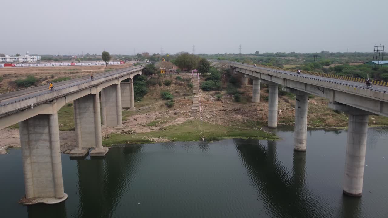 Aerial view of the highway bridge built over the river basin in the mainland Indian rural terrain