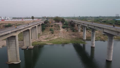 aerial view of the highway bridge built over the river basin in the mainland indian rural terrain