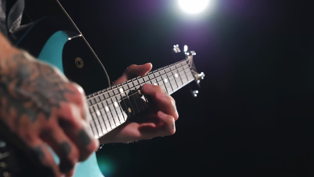 Tattooed Guitarist Playing Electric Guitar Under Spotlight, Cinematic Closeup Capturing Raw Energy