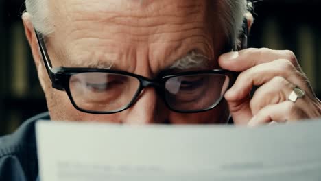 close-up of an older man concentrated reading